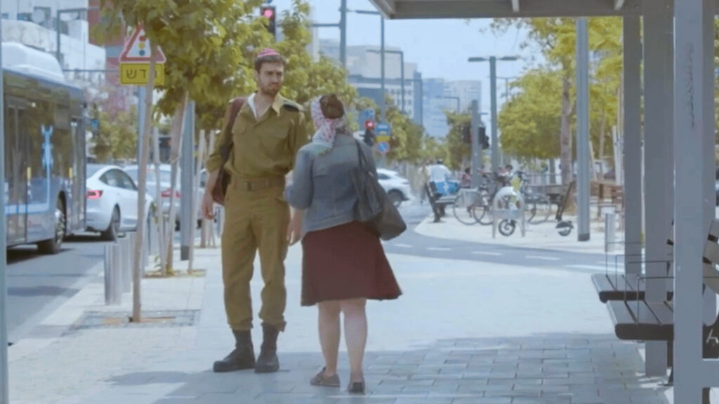 Woman and soldier standing at bus stop on city street, daylight